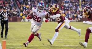 LANDOVER, MD - DECEMBER 22: Saquon Barkley #26 of the New York Giants is shoved out of bounds by Kayvon Webster #38 of the Washington Redskins during overtime at FedExField on December 22, 2019 in Landover, Maryland.