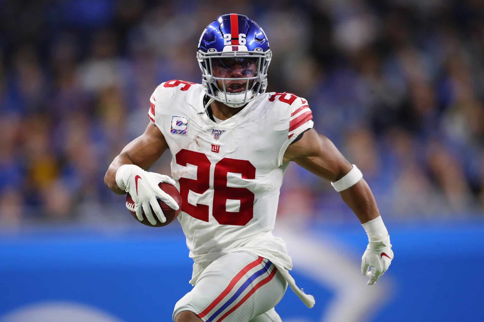 DETROIT, MICHIGAN - OCTOBER 27: Saquon Barkley #26 of the New York Giants looks for running room against the Detroit Lions in the first half at Ford Field on October 27, 2019 in Detroit, Michigan.