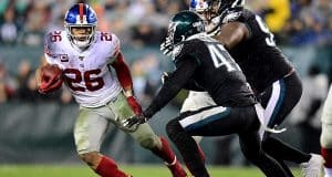 PHILADELPHIA, PENNSYLVANIA - DECEMBER 09: Running back Saquon Barkley #26 of the New York Giants carries the ball against the defense of the Philadelphia Eagles during the game at Lincoln Financial Field on December 09, 2019 in Philadelphia, Pennsylvania.
