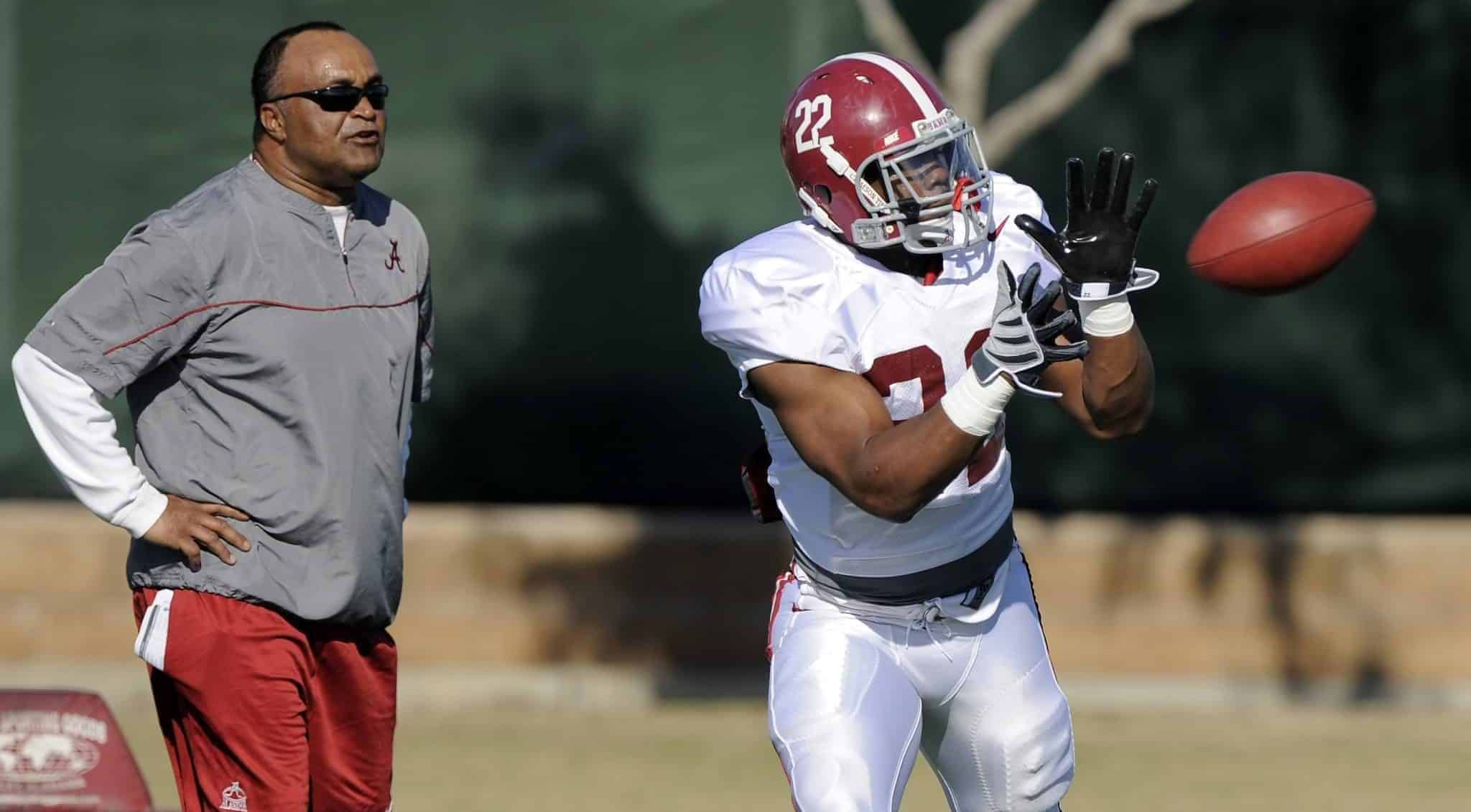 Alabama running back Mark Ingram makes a catch as associate head and running backs coach Burton Burns looks on during practice, Saturday, Jan. 2, 2010, in Costa Mesa, Calif., in preparation for their BCS Championship NCAA college football game against Texas. The game is scheduled for Thursday, Jan. 7.