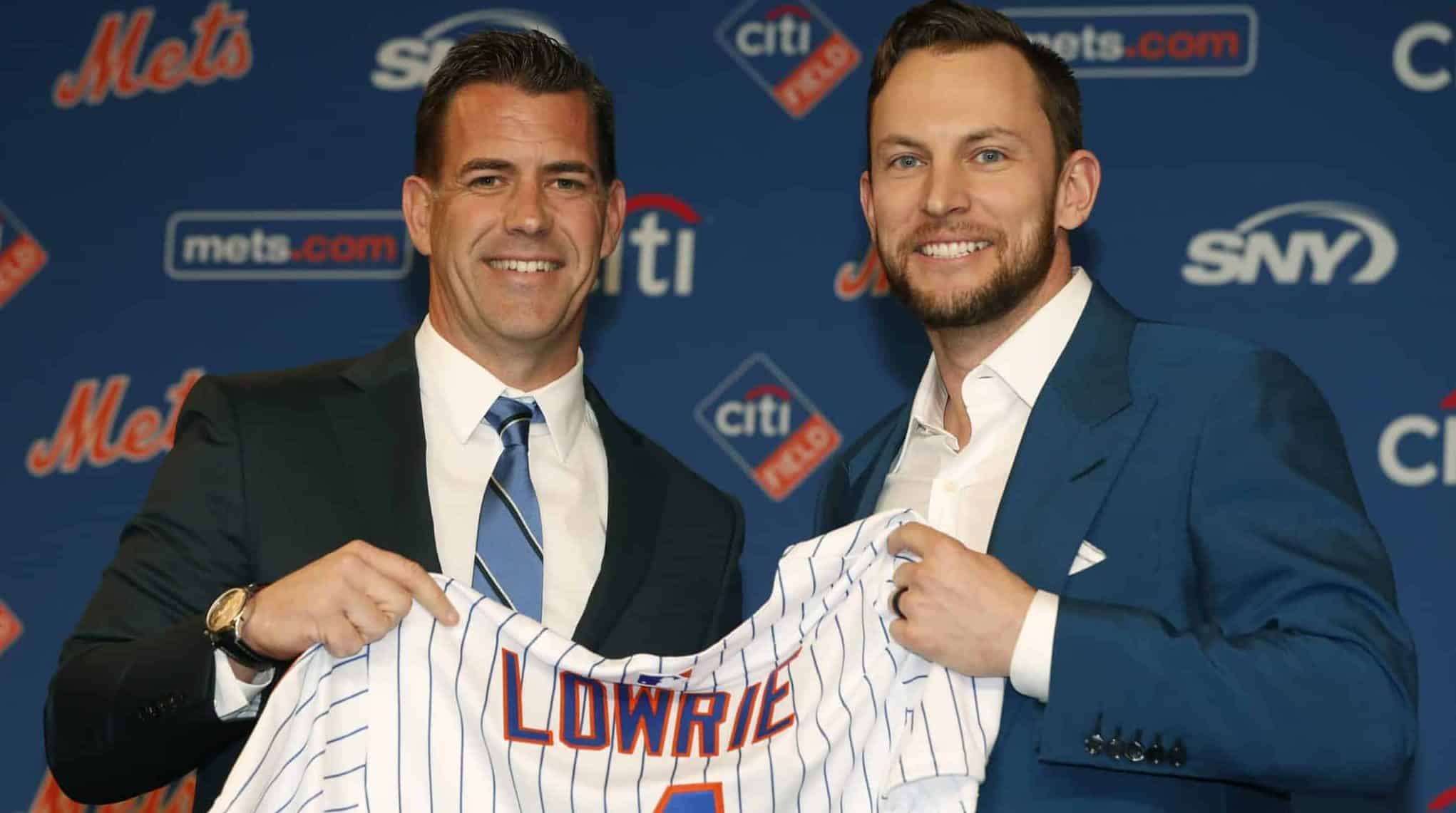 FILE - In this Jan. 16, 2019, file photo, New York Mets general manager Brodie Van Wagenen, left, poses for a photograph with new infielder Jed Lowrie during a baseball news conference in New York.
