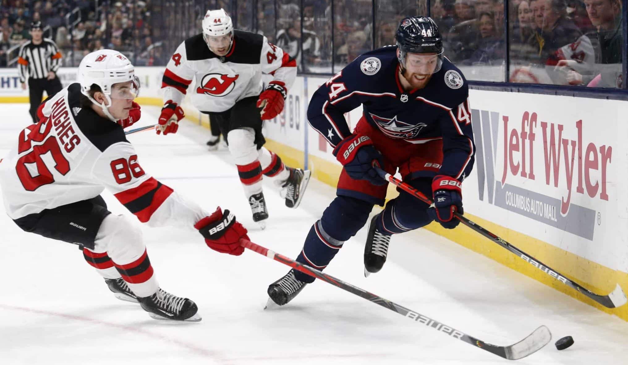 Columbus Blue Jackets defenseman Vladislav Gavrikov, right, of Russia, chases the puck in front of New Jersey forward Jack Hughes, left, and forward Miles Wood Devils during the second period an NHL hockey game in Columbus, Ohio, Saturday, Jan. 18, 2020.