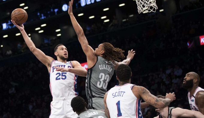 Philadelphia 76ers guard Ben Simmons (25) goes to the basket against Brooklyn Nets forward Nicolas Claxton (33) during the first half of an NBA basketball game, Monday, Jan. 20, 2020, in New York.