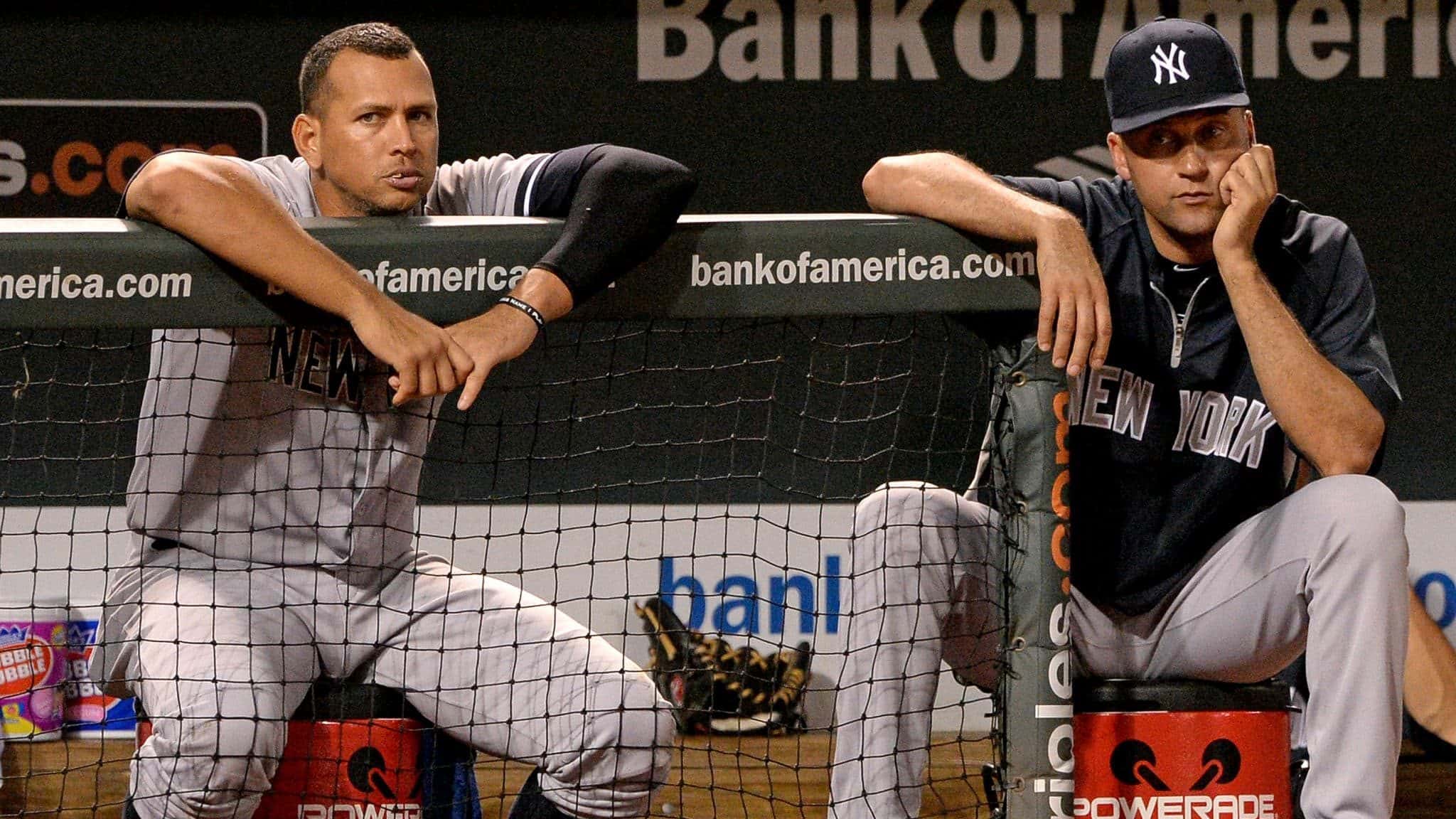 BALTIMORE, MD - SEPTEMBER 11: Alex Rodriguez #13 (L) and Derek Jeter #2 of the New York Yankees look on against the Baltimore Orioles in the ninth inning at Oriole Park at Camden Yards on September 11, 2013 in Baltimore, Maryland.