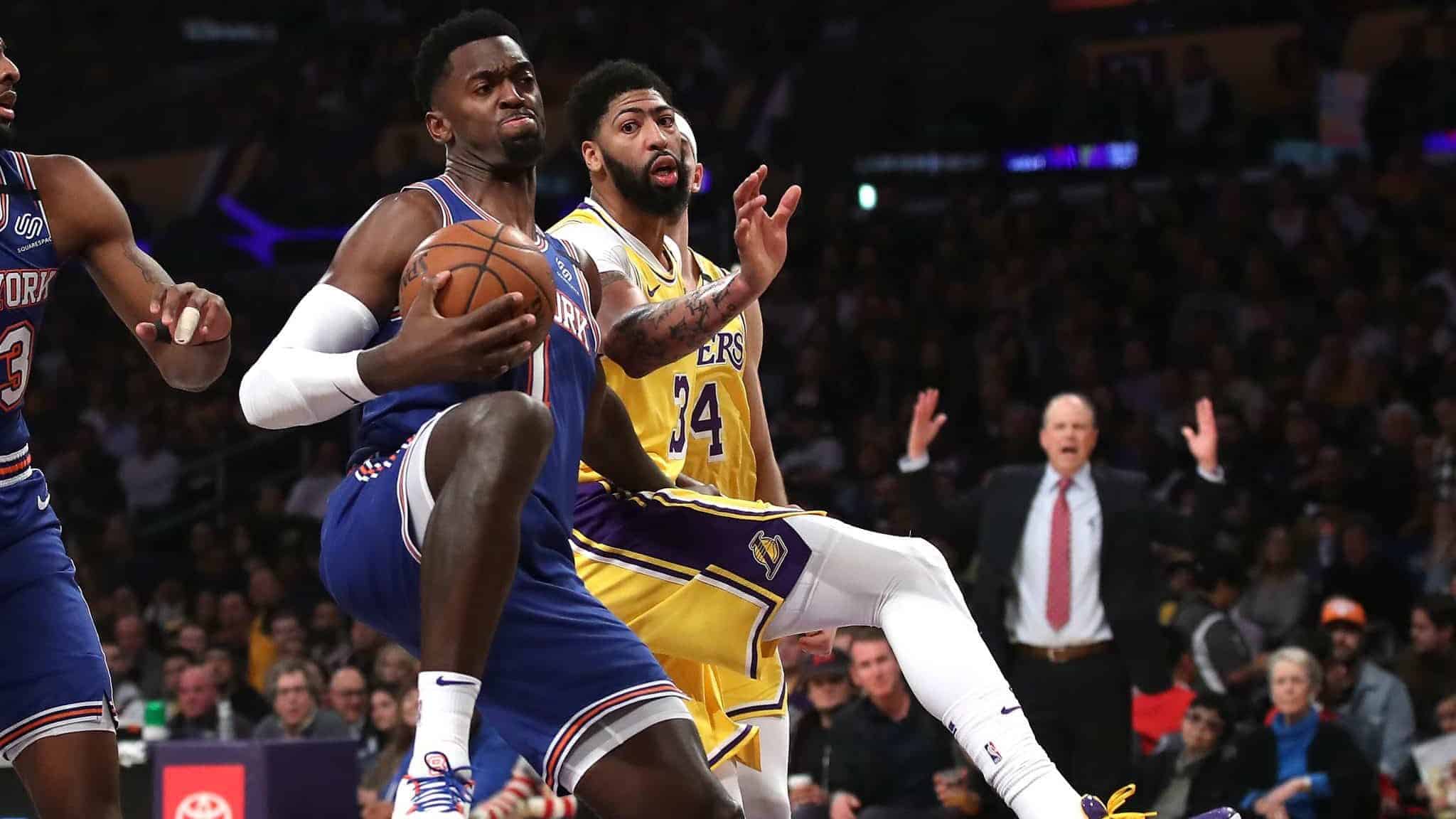LOS ANGELES, CALIFORNIA - JANUARY 07: Bobby Portis #1 of the New York Knicks rebounds past Anthony Davis #3 of the Los Angeles Lakers during the first half of a game at Staples Center on January 07, 2020 in Los Angeles, California.