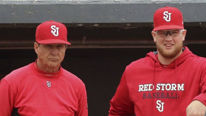 In this March 25, 2017, file photo, St. John's NCAA college baseball head coach Ed Blankmeyer, left, and pitcher Jeff Belge watch from the dugout during a game against Maine in New York. Blankmeyer went into this season expecting his St. John's baseball team to get off to a solid start. But not even the veteran coach could have predicted the Red Storm to roll quite like this. They're soaring up the national polls at 18-2, their best start since the 1981 squad that featured future major leaguers Frank Viola and John Franco opened 26-1.