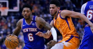 Knicks guard Elfrid Payton (6) drives against Phoenix Suns guard Devin Booker in the first half during an NBA basketball game, Friday, Jan. 3, 2020, in Phoenix.
