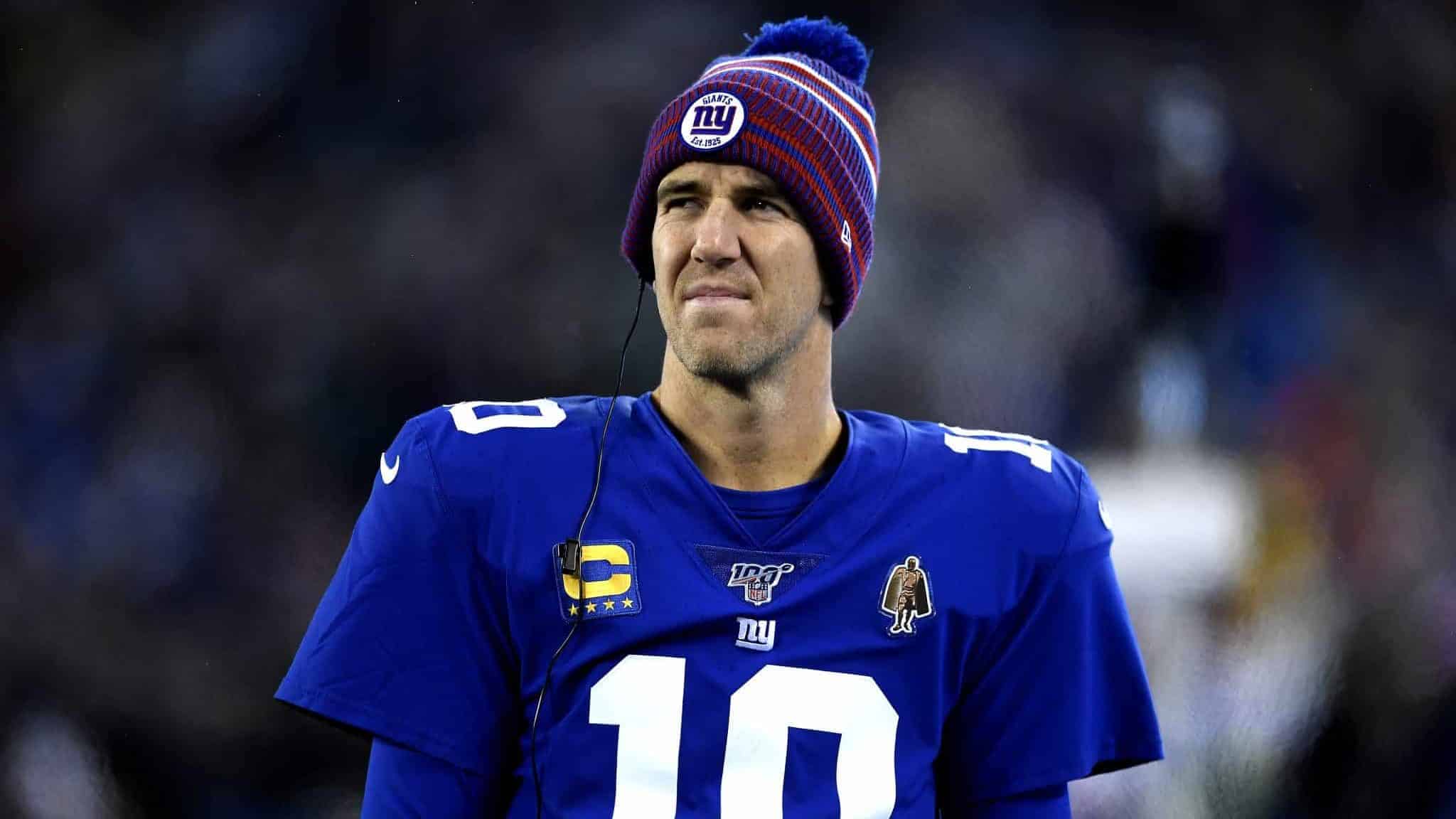 EAST RUTHERFORD, NEW JERSEY - DECEMBER 29: Eli Manning #10 of the New York Giants looks on from the sidelines against the Philadelphia Eagles during the first quarter in the game at MetLife Stadium on December 29, 2019 in East Rutherford, New Jersey.