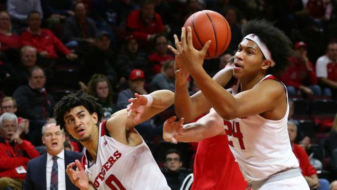 PISCATAWAY, NJ - JANUARY 09: Ron Harper Jr. #24 of the Rutgers Scarlet Knights grabs a rebound with help from teammate Geo Baker #0 against Kyle Young #25 of the Ohio State Buckeyes during the first half a game at Rutgers Athletic Center on January 9, 2019 in Piscataway, New Jersey.