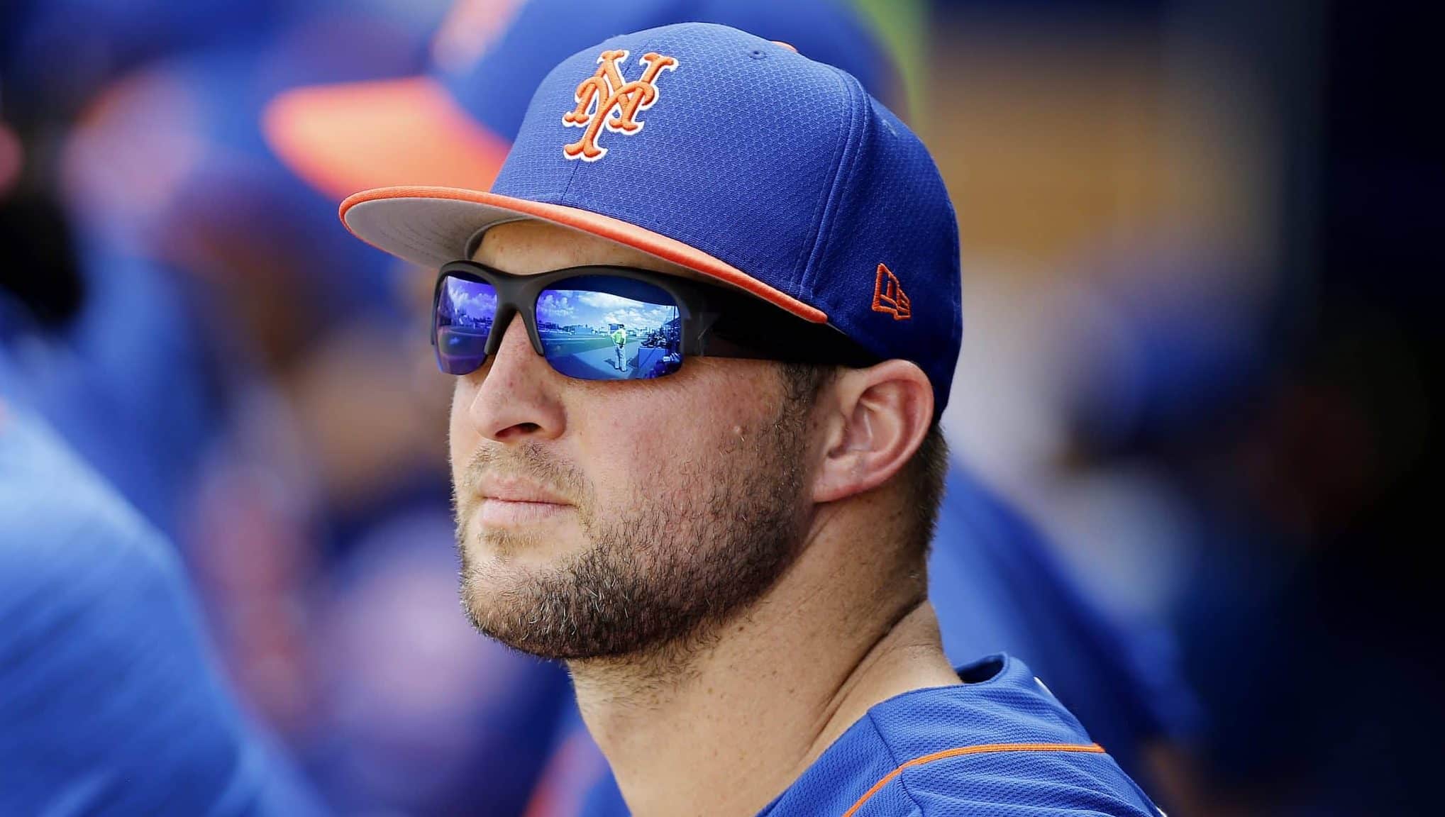 PORT ST. LUCIE, FLORIDA - FEBRUARY 23: Tim Tebow #15 of the New York Mets looks on in the dugout against the Atlanta Braves during the Grapefruit League spring training game at First Data Field on February 23, 2019 in Port St. Lucie, Florida.