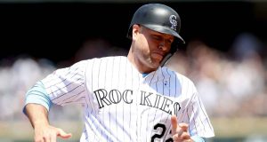 DENVER, COLORADO - JUNE 16: Chris Iannetta #22 of the Colorado Rockies rounds third base to score on a fielding error on a hit by Charlie Blackmon in the first inning against the San Diego Padres at Coors Field on June 16, 2019 in Denver, Colorado.