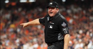HOUSTON, TEXAS - OCTOBER 29: umpire Sam Holbrook #34 reacts after making a runner interface call on Trea Turner (not pictured) of the Washington Nationals during the seventh inning in Game Six of the 2019 World Series between the Houston Astros and the Washington Nationals at Minute Maid Park on October 29, 2019 in Houston, Texas.
