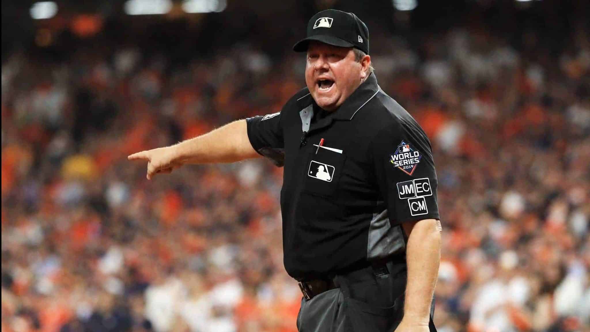 HOUSTON, TEXAS - OCTOBER 29: umpire Sam Holbrook #34 reacts after making a runner interface call on Trea Turner (not pictured) of the Washington Nationals during the seventh inning in Game Six of the 2019 World Series between the Houston Astros and the Washington Nationals at Minute Maid Park on October 29, 2019 in Houston, Texas.