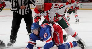 NEWARK, NEW JERSEY - NOVEMBER 30: Mika Zibanejad #93 of the New York Rangers and Travis Zajac #19 of the New Jersey Devils fight for the puck in the second period at Prudential Center on November 30, 2019 in Newark, New Jersey.