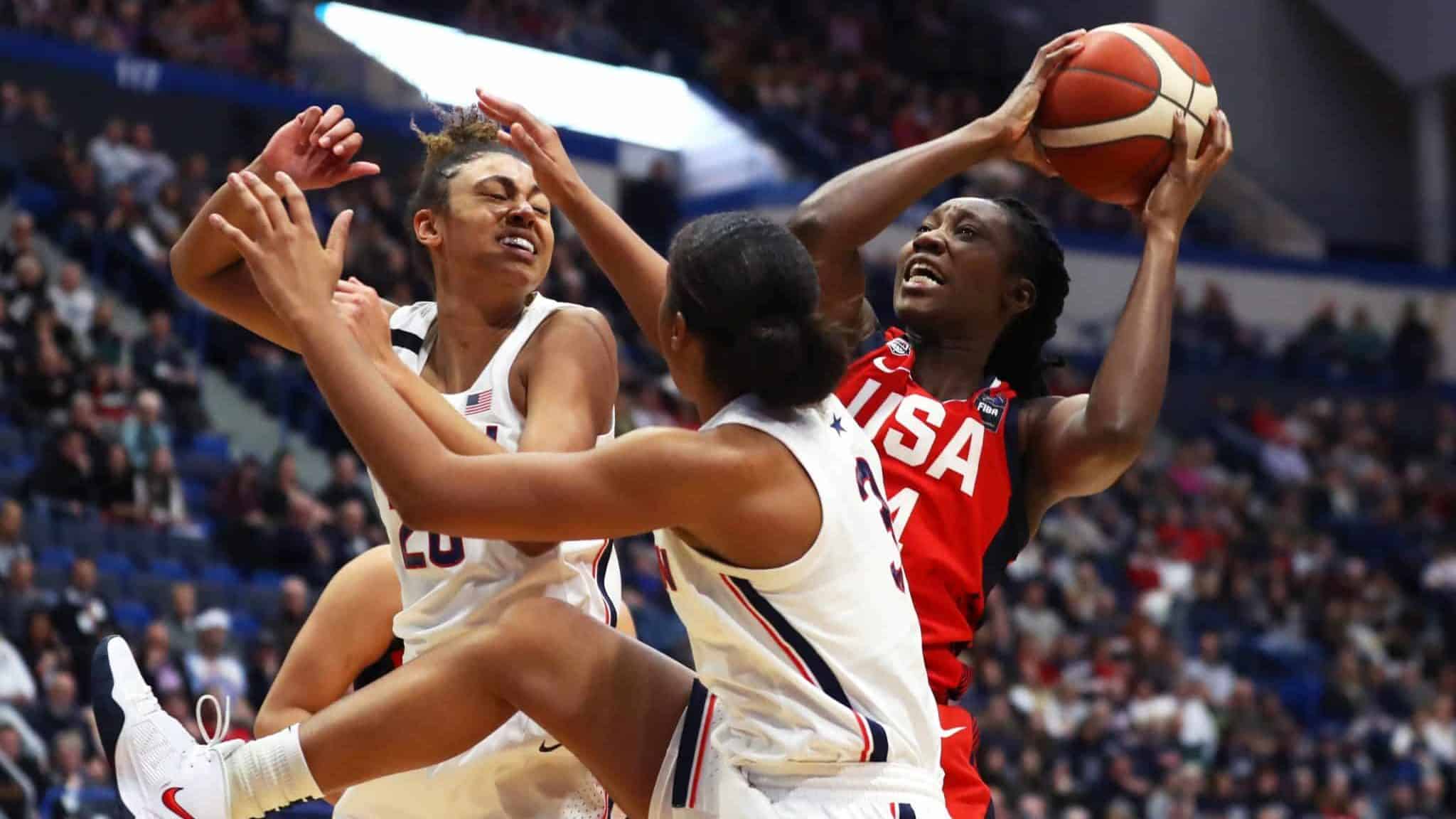 HARTFORD, CONNECTICUT - JANUARY 27: Tina Charles #14 of the United States looks for a shot over Megan Walker #3 and Olivia Nelson-Ododa #20 of the UConn Huskies during USA Women's National Team Winter Tour 2020 game between the United States and the UConn Huskies at The XL Center on January 27, 2020 in Hartford, Connecticut.