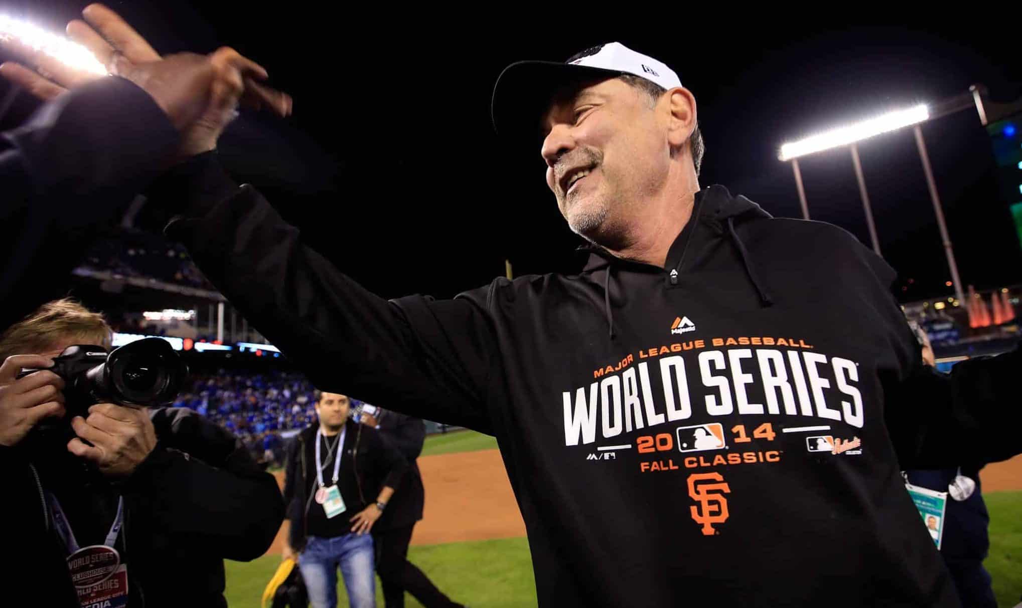 KANSAS CITY, MO - OCTOBER 29: Manager Bruce Bochy #15 of the San Francisco Giants celebrates on the field after defeating the Kansas City Royals 3-2 to win Game Seven of the 2014 World Series at Kauffman Stadium on October 29, 2014 in Kansas City, Missouri.