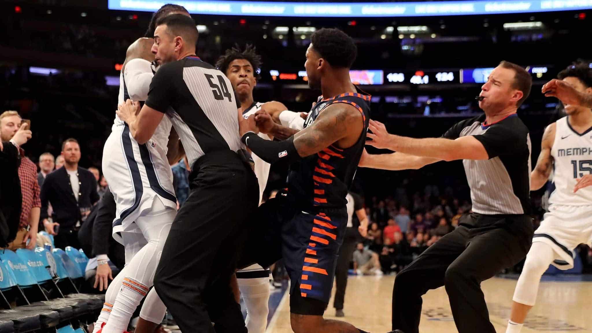 NEW YORK, NEW YORK - JANUARY 29: The referees try to break up a fight between Jae Crowder #99 of the Memphis Grizzlies and Elfrid Payton #6 of the New York Knicks as the benches clear in the final minute of the game at Madison Square Garden on January 29, 2020 in New York City.The Memphis Grizzlies defeated the New York Knicks 127-106.NOTE TO USER: User expressly acknowledges and agrees that, by downloading and or using this photograph, User is consenting to the terms and conditions of the Getty Images License Agreement.