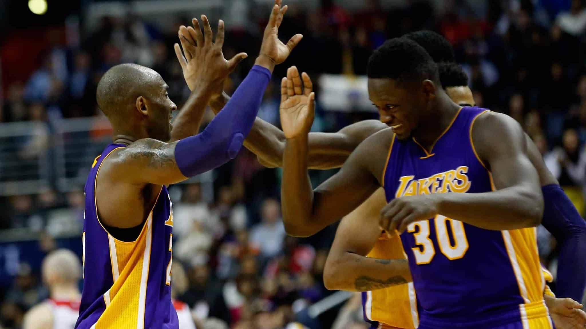 WASHINGTON, DC - DECEMBER 02: Kobe Bryant #24 of the Los Angeles Lakers celebrates with Julius Randle #30 during a timeout in the second half against the Washington Wizards at Verizon Center on December 2, 2015 in Washington, DC. NOTE TO USER: User expressly acknowledges and agrees that, by downloading and or using this photograph, User is consenting to the terms and conditions of the Getty Images License Agreement.