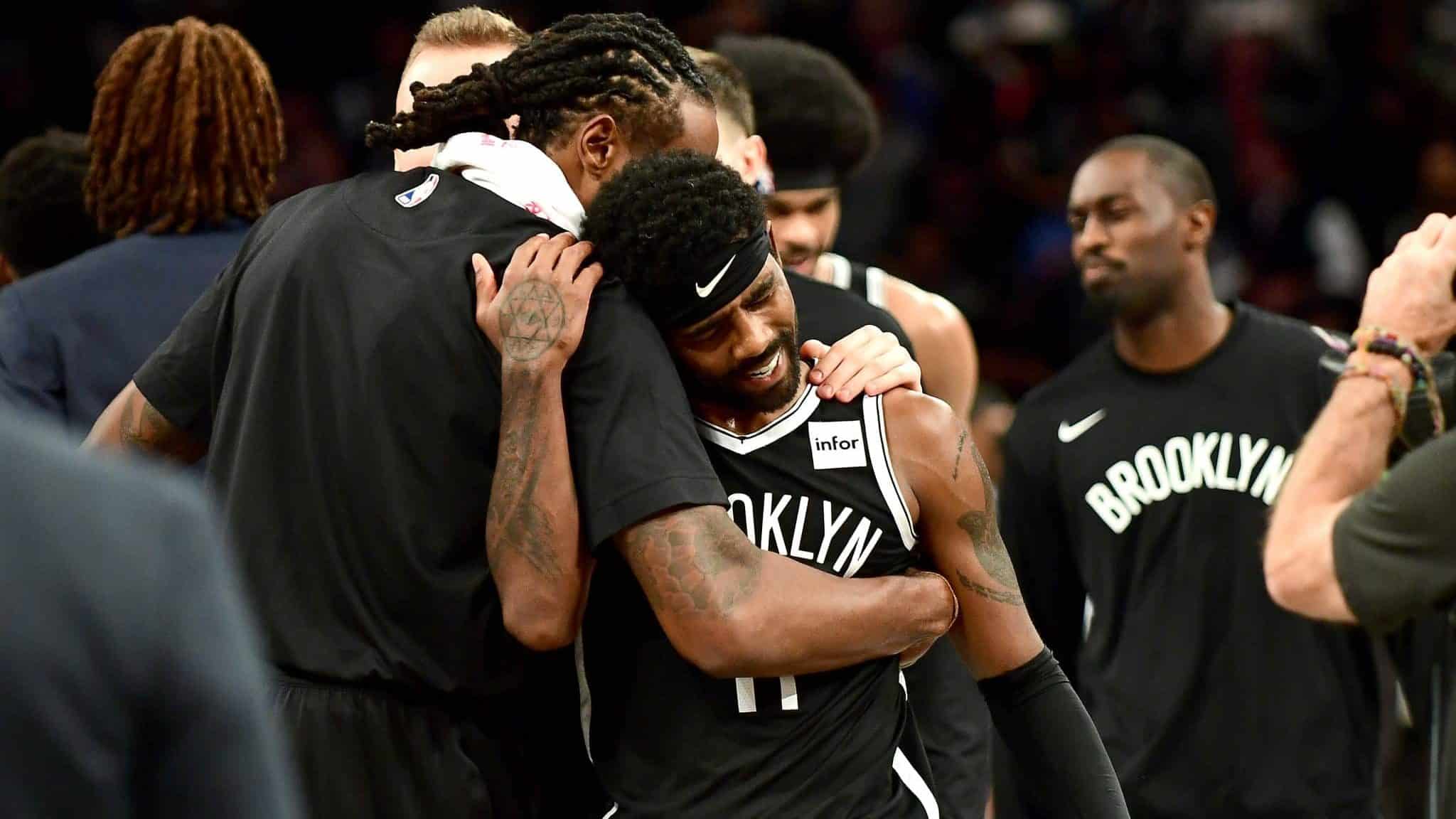 NEW YORK, NEW YORK - OCTOBER 23: DeAndre Jordan #6 hugs Kyrie Irving #11 of the Brooklyn Nets after their 127-126 loss to the Minnesota Timberwolves at Barclays Center on October 23, 2019 in the Brooklyn borough of New York City. NOTE TO USER: User expressly acknowledges and agrees that, by downloading and or using this photograph, User is consenting to the terms and conditions of the Getty Images License Agreement.