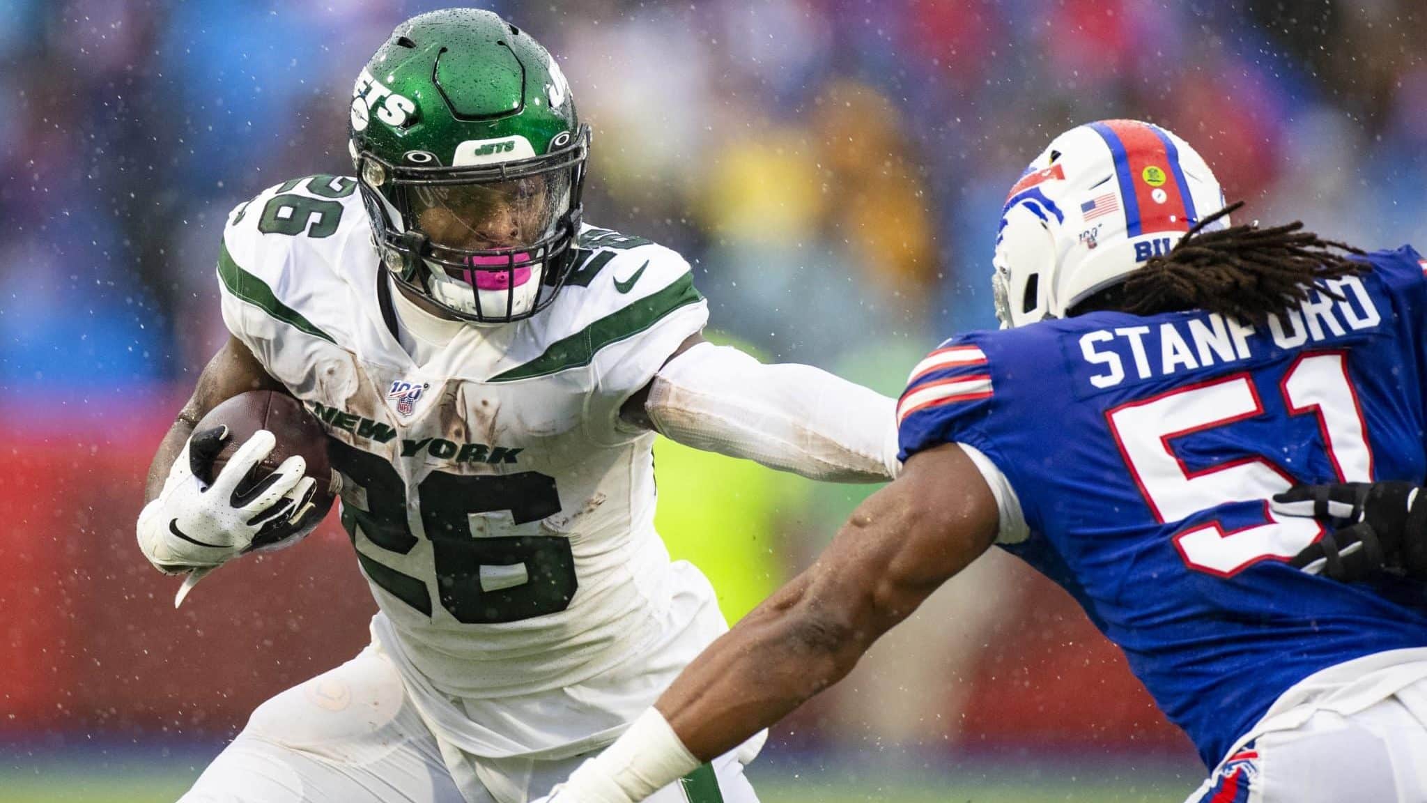 ORCHARD PARK, NY - DECEMBER 29: Le'Veon Bell #26 of the New York Jets delivers a stiff arm against Julian Stanford #51 of the Buffalo Bills during the second quarter at New Era Field on December 29, 2019 in Orchard Park, New York.