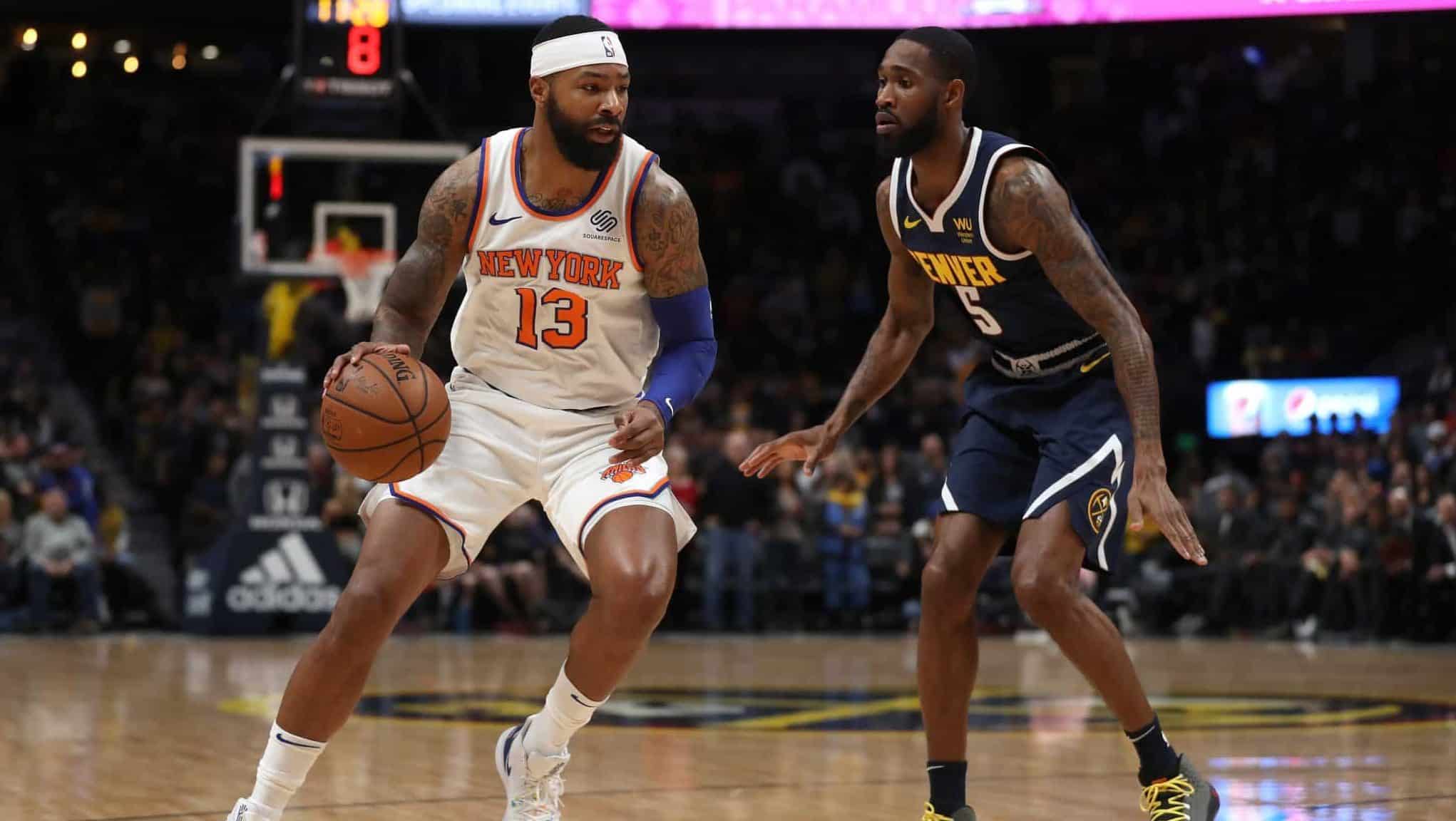 DENVER, COLORADO - DECEMBER 15: Marcus Morris Sr. #13 of the New York Knicks drives against Will Barton III #5 of the Denver Nuggets in the first quarter at the Pepsi Center on December 15, 2019 in Denver, Colorado. NOTE TO USER: User expressly acknowledges and agrees that, by downloading and or using this photograph, User is consenting to the terms and conditions of the Getty Images License Agreement.
