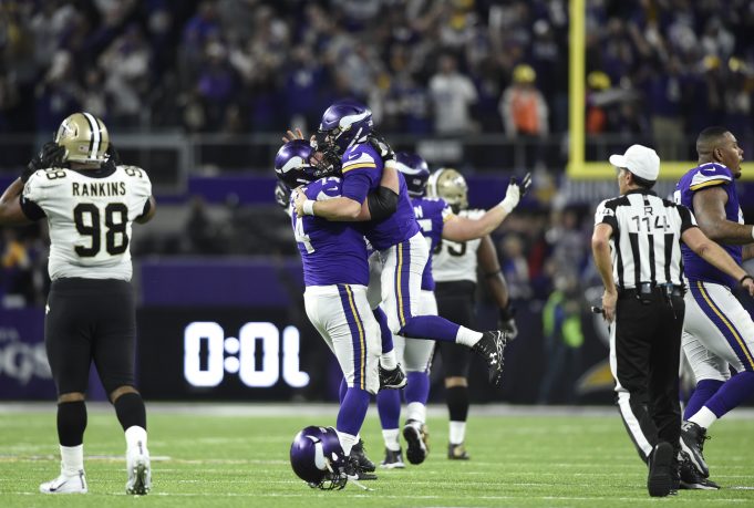 MINNEAPOLIS, MN - JANUARY 14: Case Keenum #7 of the Minnesota Vikings celebrates with teammate Mike Remmers #74 after completing a 61 yard touchdown pass to win the NFC Divisional Playoff game against the New Orleans Saints on January 14, 2018 at U.S. Bank Stadium in Minneapolis, Minnesota. The Vikings defeated the Saints 29-24.