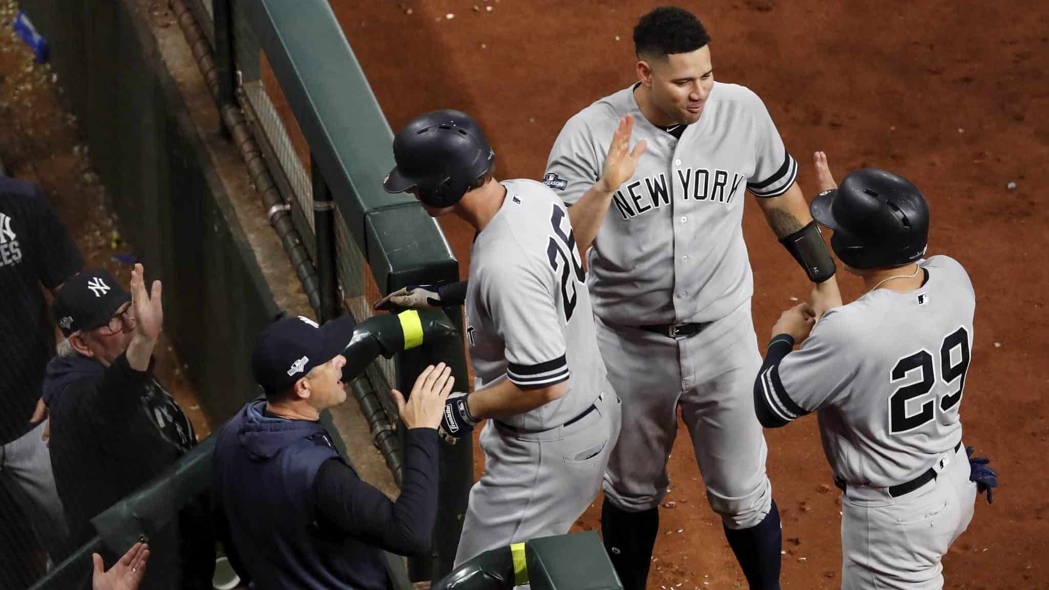HOUSTON, TX - OCTOBER 19: DJ LeMahieu #26 of the New York Yankees is congratulated in the dugout after a home run in the ninth inning against the Houston Astros during Game Six of the League Championship Series at Minute Maid Park on October 19, 2019 in Houston, Texas.