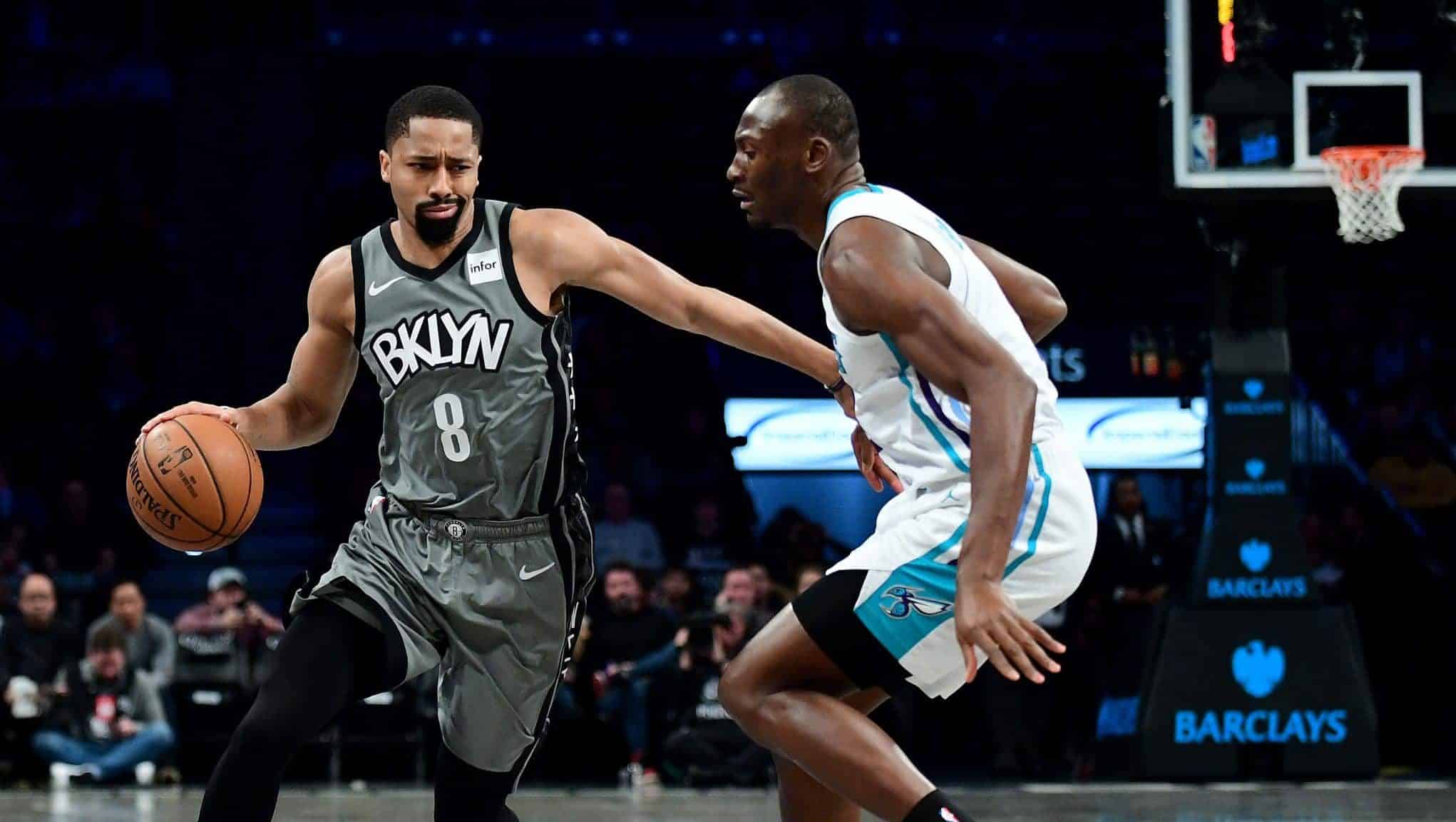 NEW YORK, NEW YORK - DECEMBER 11: Spencer Dinwiddie #8 of the Brooklyn Nets drives past Bismack Biyombo #8 of the Charlotte Hornets during the first half at Barclays Center on December 11, 2019 in New York City. NOTE TO USER: User expressly acknowledges and agrees that, by downloading and or using this photograph, User is consenting to the terms and conditions of the Getty Images License Agreement.