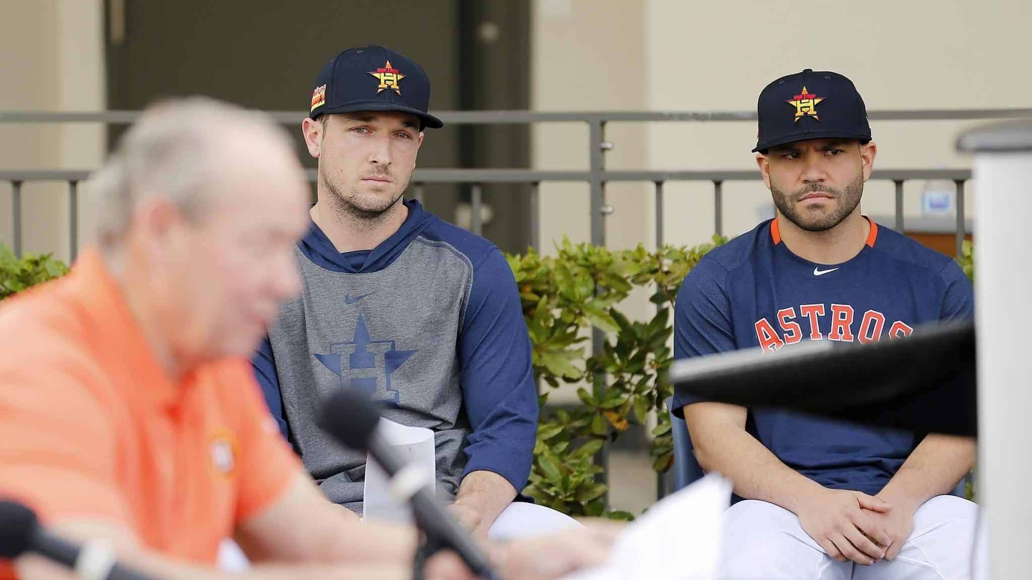 WEST PALM BEACH, FLORIDA - FEBRUARY 13: Alex Bregman #2 and Jose Altuve #27 of the Houston Astros look on as owner Jim Crane reads a prepared statement during a press conference at FITTEAM Ballpark of The Palm Beaches on February 13, 2020 in West Palm Beach, Florida.