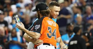 MIAMI, FL - JULY 10: Aaron Judge #99 of the New York Yankees hugs Bryce Harper #34 of the Washington Nationals and the National League in the T-Mobile Home Run Derby at Marlins Park on July 10, 2017 in Miami, Florida.