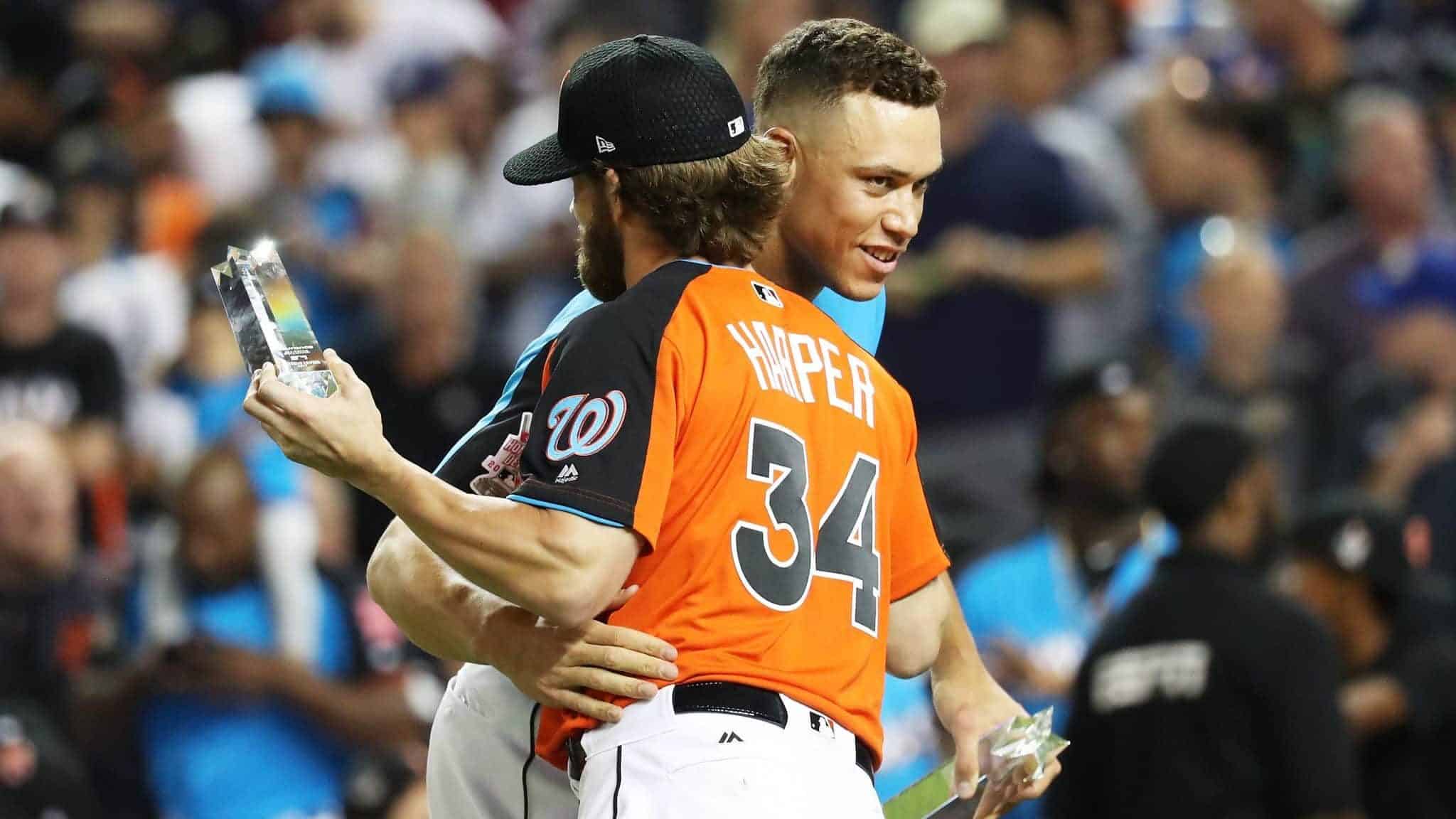 MIAMI, FL - JULY 10: Aaron Judge #99 of the New York Yankees hugs Bryce Harper #34 of the Washington Nationals and the National League in the T-Mobile Home Run Derby at Marlins Park on July 10, 2017 in Miami, Florida.
