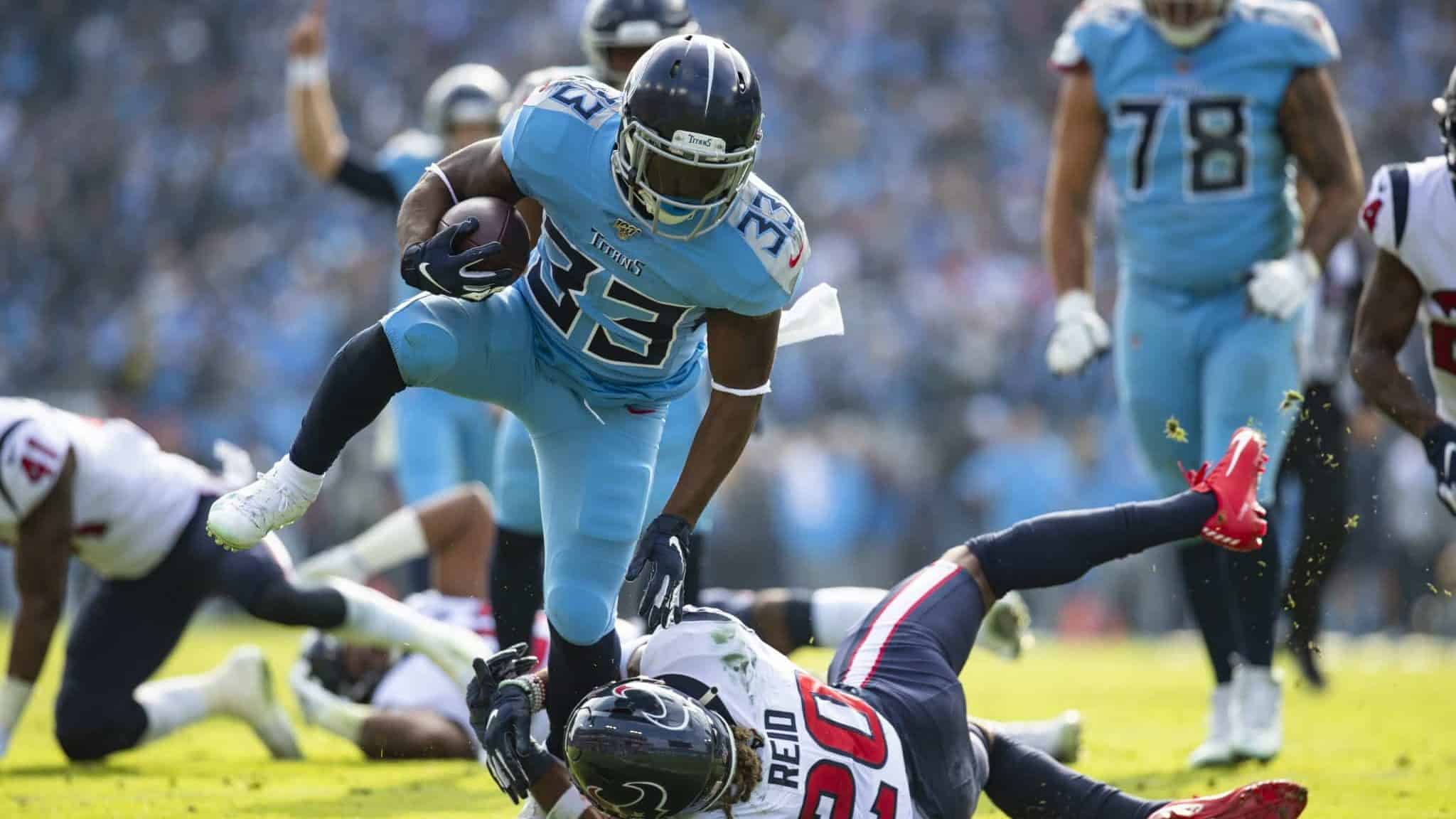 NASHVILLE, TN - DECEMBER 15: Justin Reid #20 of the Houston Texans trips up Dion Lewis #33 of the Tennessee Titans as he carries the ball in the red zone during the second quarter at Nissan Stadium on December 15, 2019 in Nashville, Tennessee.