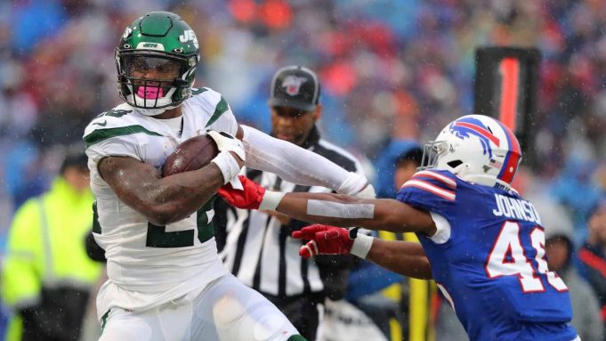 ORCHARD PARK, NY - DECEMBER 29: Jaquan Johnson #46 of the Buffalo Bills tries to make a tackle on Le'Veon Bell #26 of the New York Jets as he runs the ball during the first half at New Era Field on December 29, 2019 in Orchard Park, New York.