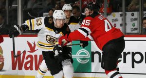 NEWARK, NJ - DECEMBER 31: Brad Marchand #63 of the Boston Bruins tries to skate past Sami Vatanen #45 of the New Jersey Devils during an NHL hockey game on December 31, 2019 at the Prudential Center in Newark, New Jersey. Devils won 3-2 in a shootout.