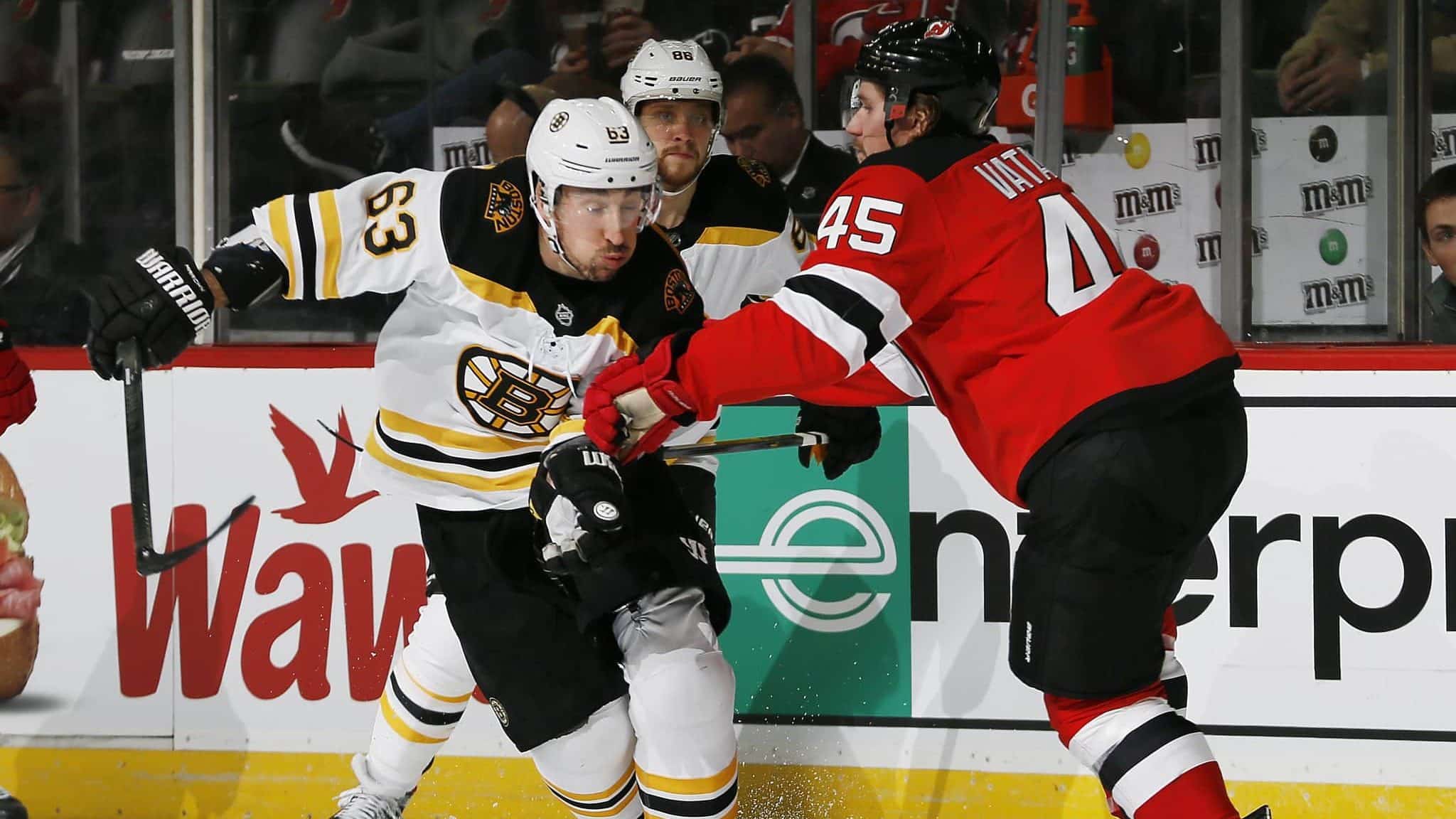 NEWARK, NJ - DECEMBER 31: Brad Marchand #63 of the Boston Bruins tries to skate past Sami Vatanen #45 of the New Jersey Devils during an NHL hockey game on December 31, 2019 at the Prudential Center in Newark, New Jersey. Devils won 3-2 in a shootout.