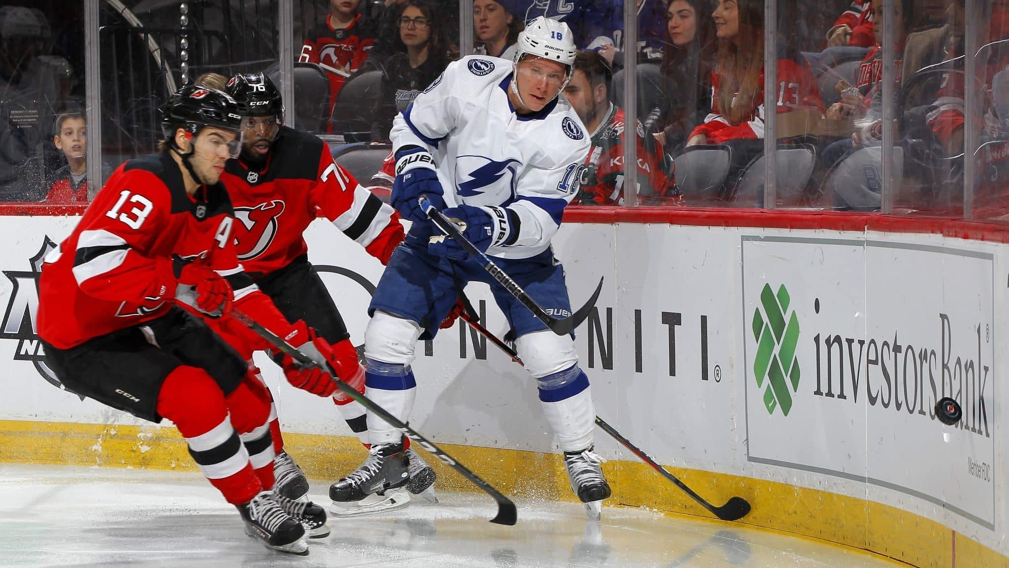 NEWARK, NEW JERSEY - JANUARY 12: Ondrej Palat #18 of the Tampa Bay Lightning clears the puck away from Nico Hischier #13 and P.K. Subban #76 of the New Jersey Devils during the first period at Prudential Center on January 12, 2020 in Newark, New Jersey.