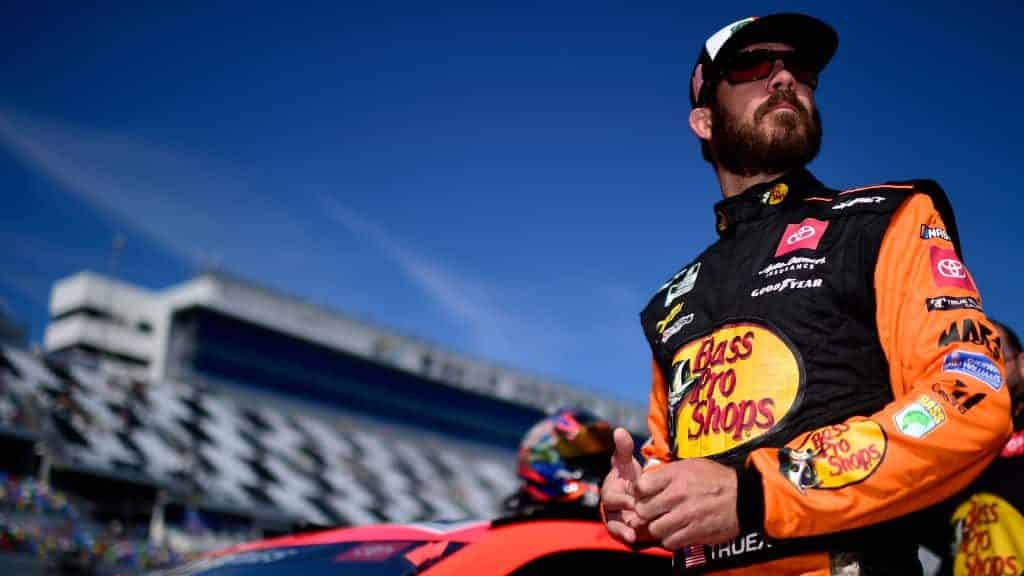 DAYTONA BEACH, FLORIDA - FEBRUARY 09: Martin Truex Jr., driver of the #19 Bass Pros Shops Toyota, stands on the grid during qualifying for the NASCAR Cup Series 62nd Annual Daytona 500 at Daytona International Speedway on February 09, 2020 in Daytona Beach, Florida.