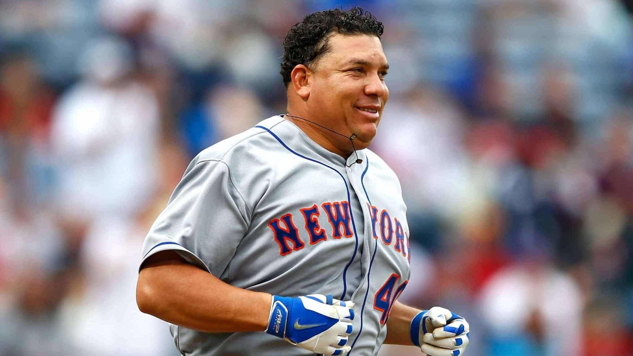 ATLANTA, GA - APRIL 12: Bartolo Colon #40 of the New York Mets runs to first base after hitting a RBI single into right field against the Atlanta Braves during the Braves opening series at Turner Field on April 12, 2015 in Atlanta, Georgia. Wilmer Flores #4 scored on the single.