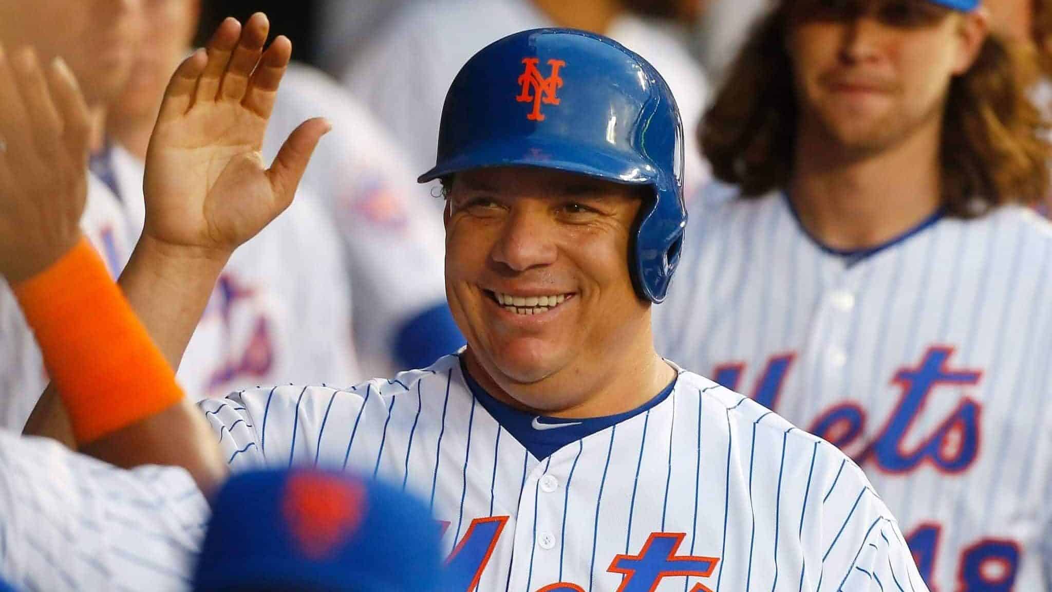 NEW YORK, NY - JUNE 16: Bartolo Colon #40 of the New York Mets celebrates in the dugout after scoring a third-inning run against the Pittsburgh Pirates at Citi Field on June 16, 2016 in the Flushing neighborhood of the Queens borough of New York City.