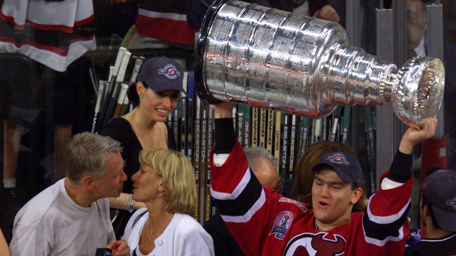 10 Jun 2000: Bobby Holik #16 of the New Jersey Devils hoists the Stanley Cup as his parents celebrate along with him after the New Jersey Devils won Game Six of the 2000 NHL Stanley Cup Finals between the Dallas Stars and the New Jersey Devils at Reunion Arena in Dallas, Texas. The Devils defeated the Stars 2-1 in the second overtime period to win the Stanley Cup. DIGITAL IMAGE.