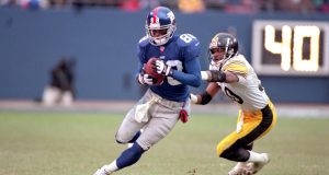 10 Dec 2000: Ike Hilliard #88 of the New York Giants runs with the ball against Chad Scott #30 of the Pittsburgh Steelers during the game at the Giants Stadium in East Rutherford, New Jersey. The Giants defeated the Steelers 30-10.