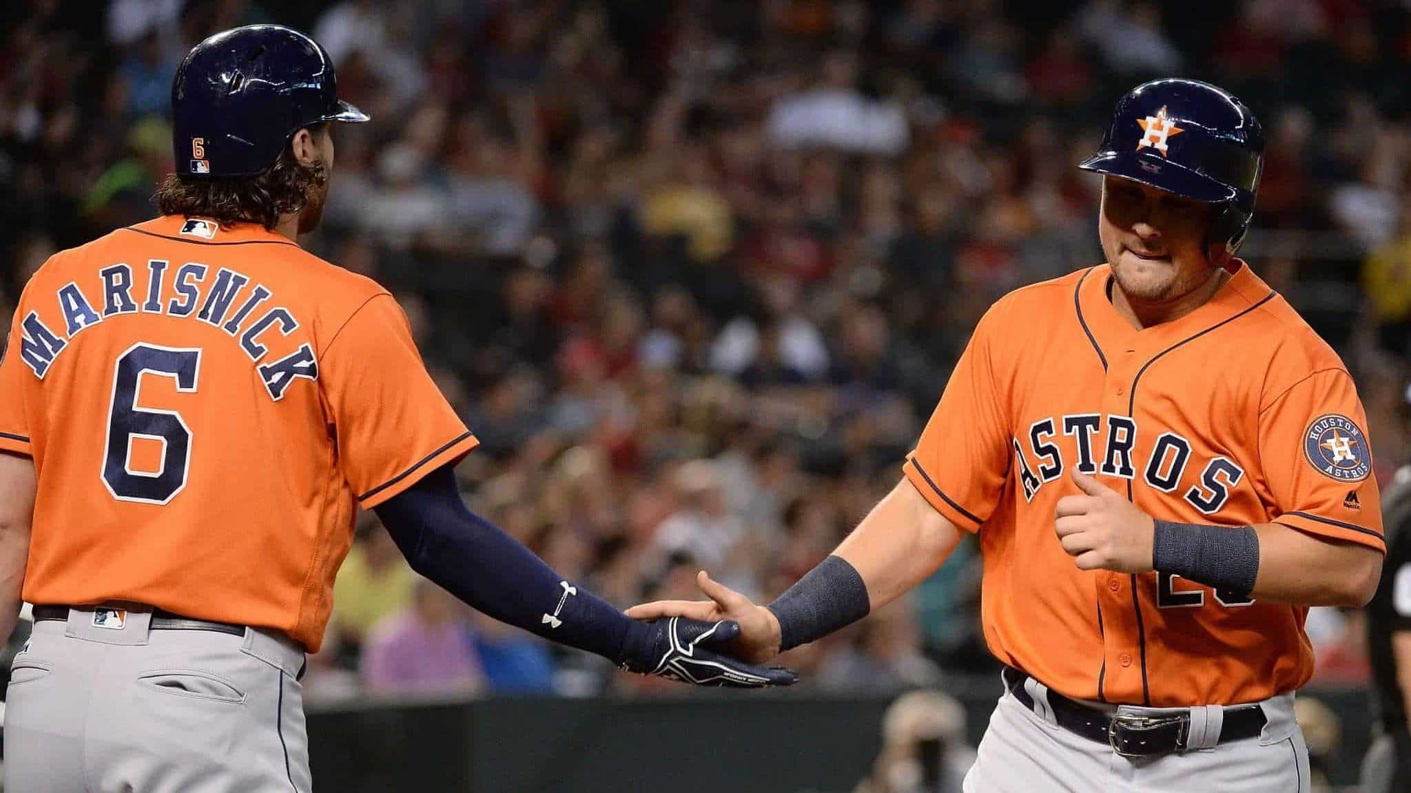 PHOENIX, AZ - AUGUST 15: J.D. Davis #28 of the Houston Astros is congratulated by Jake Marisnick #6 after scoring against the Arizona Diamondbacks in the second inning at Chase Field on August 15, 2017 in Phoenix, Arizona.