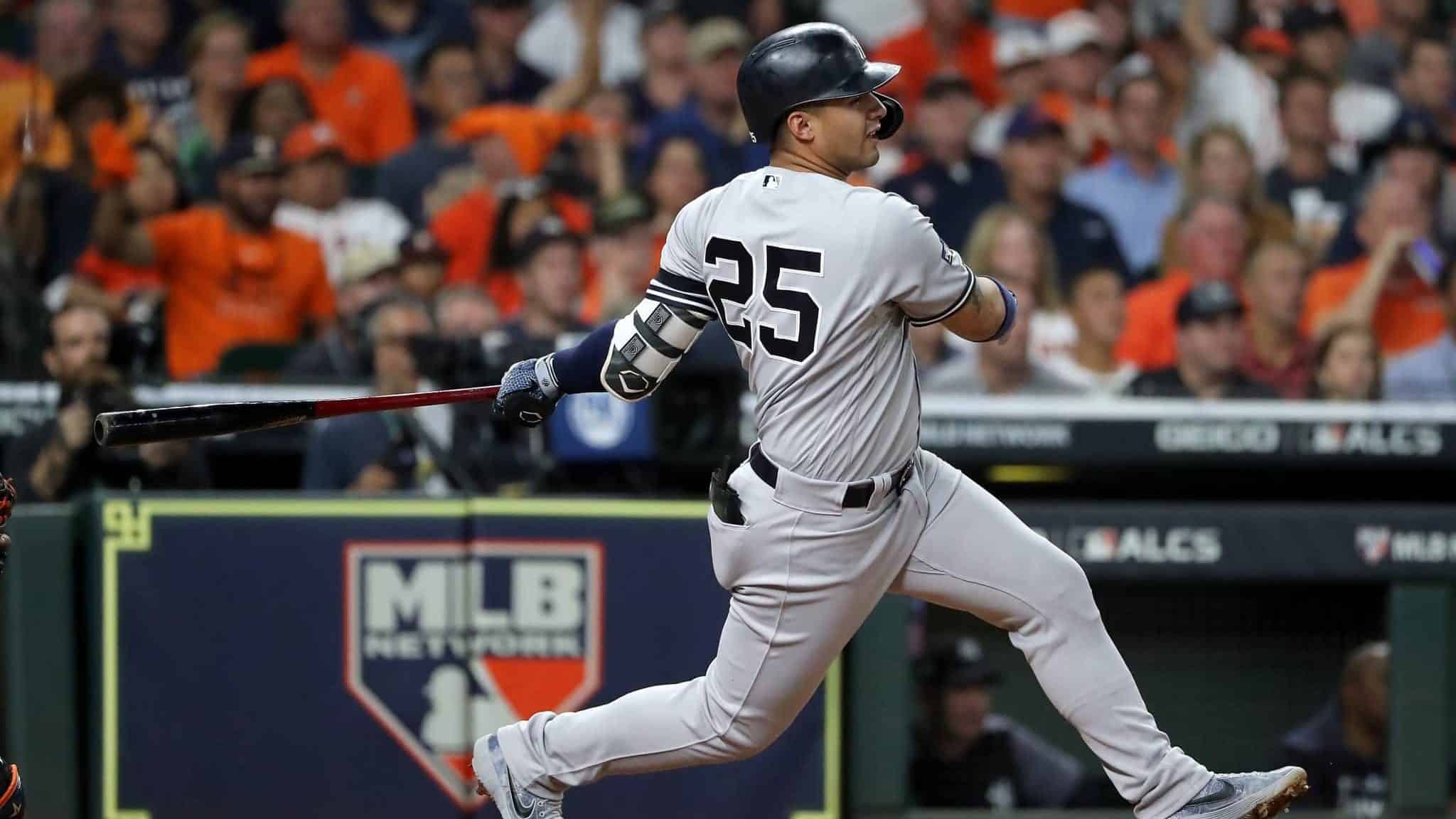 HOUSTON, TEXAS - OCTOBER 19: Gleyber Torres #25 of the New York Yankees hits a single against the Houston Astros during the third inning in game six of the American League Championship Series at Minute Maid Park on October 19, 2019 in Houston, Texas.