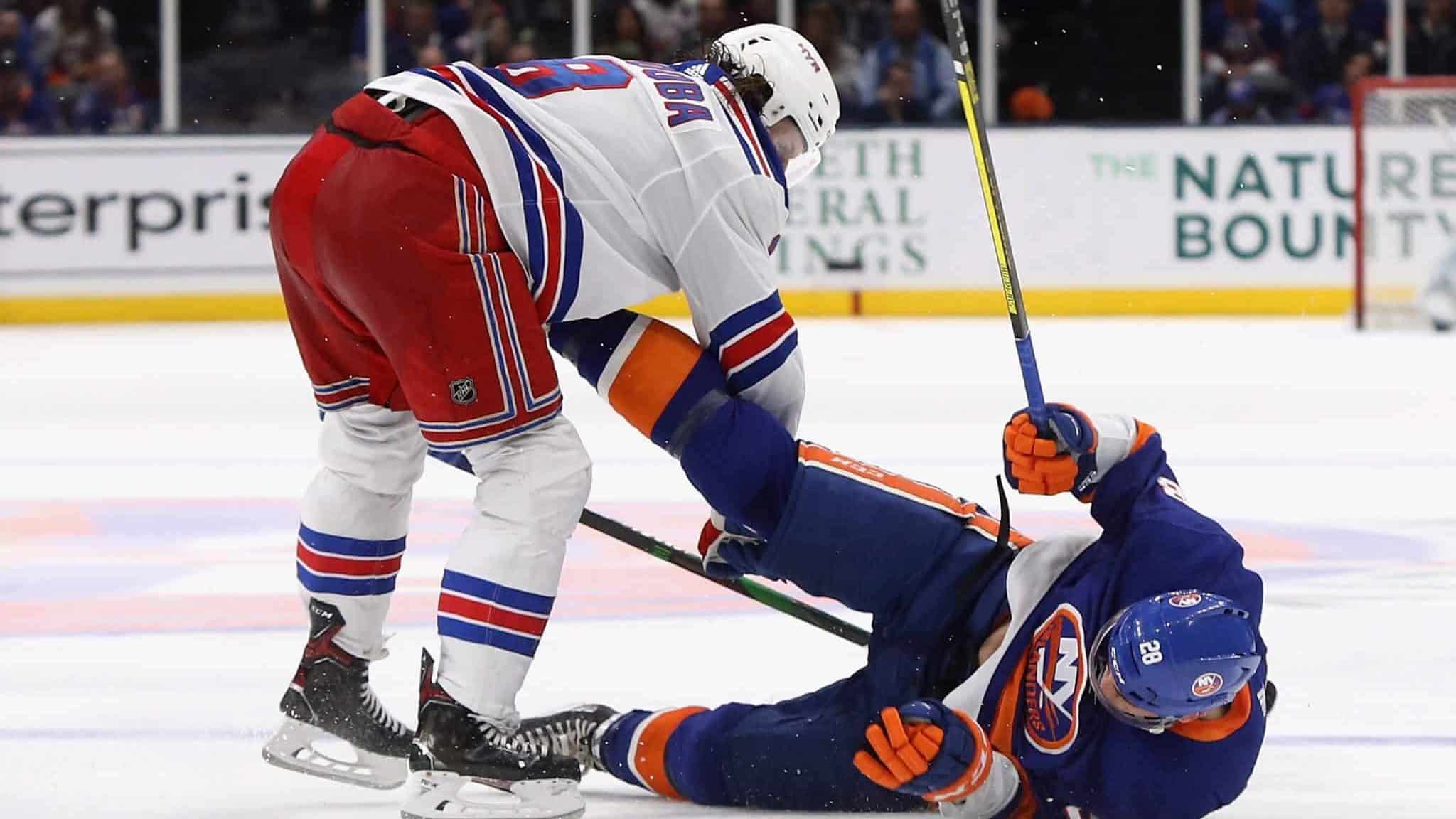 NEW YORK, NEW YORK - FEBRUARY 25: Jacob Trouba #8 of the New York Rangers checks Michael Dal Colle #28 of the New York Islanders during the third period at NYCB Live's Nassau Coliseum on February 25, 2020 in Uniondale, New York. The Rangers defeated the Islanders 4-3 in overtime.