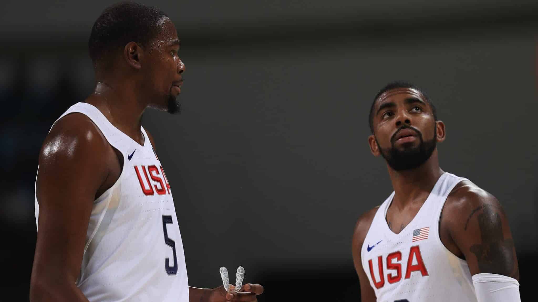 RIO DE JANEIRO, BRAZIL - AUGUST 08: Kevin Durant #5 and Kyrie Irving #10 of United States talk on the court during the Men's Priliminary Round between the United States and Venezuela on Day 3 of the Rio 2016 Olympic Games at Carioca Arena 1 on August 8, 2016 in Rio de Janeiro, Brazil.