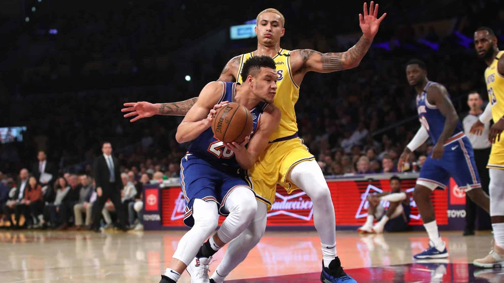 LOS ANGELES, CALIFORNIA - JANUARY 07: Kyle Kuzma #0 of the Los Angeles Lakers defends against Kevin Knox II #20 of the New York Knicks during the first half of a game at Staples Center on January 07, 2020 in Los Angeles, California. NOTE TO USER: User expressly acknowledges and agrees that, by downloading and/or using this photograph, user is consenting to the terms and conditions of the Getty Images License Agreement