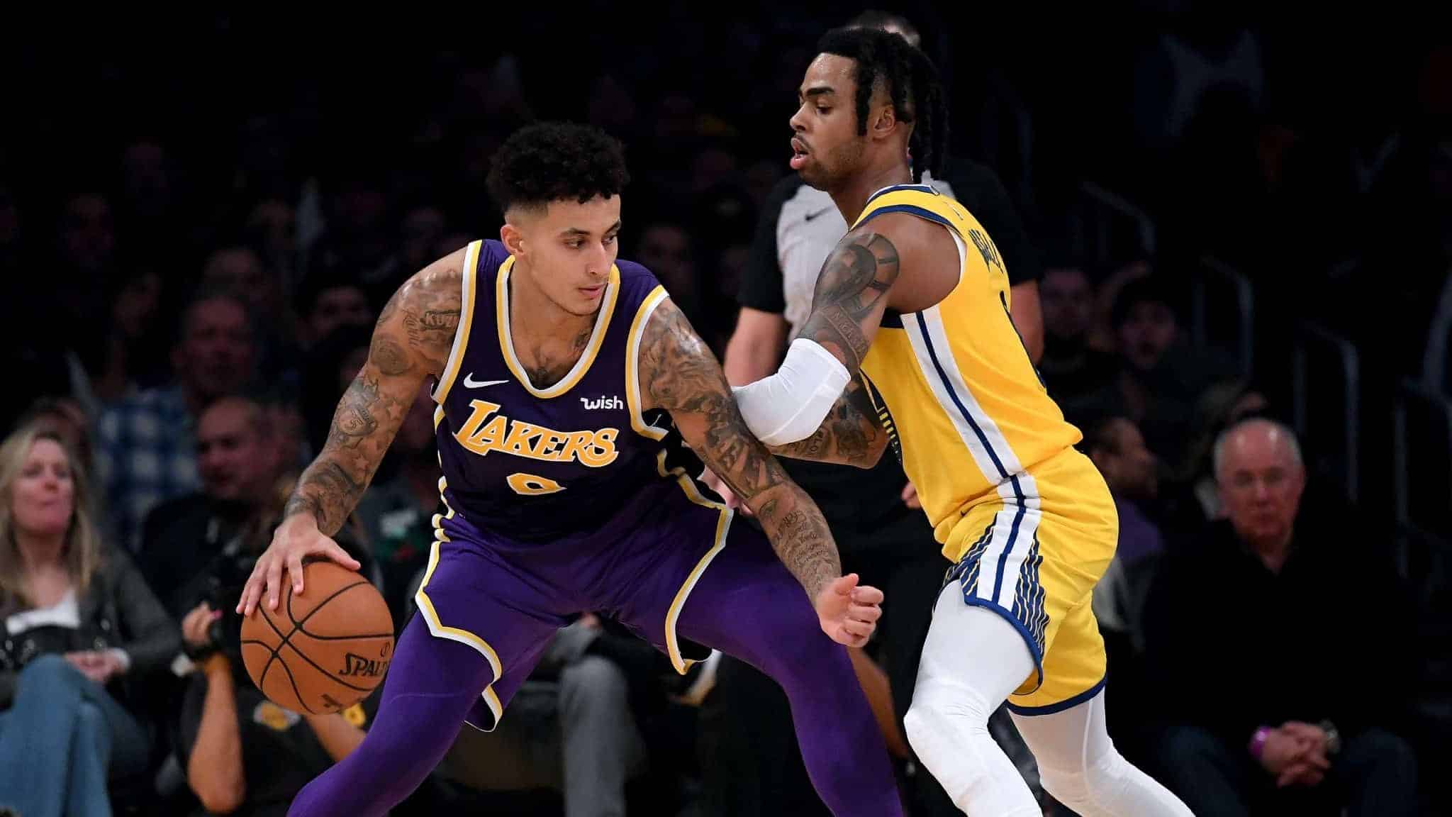 LOS ANGELES, CALIFORNIA - NOVEMBER 13: Kyle Kuzma #0 of the Los Angeles Lakers posts up D'Angelo Russell #0 of the Golden State Warriors during a 120-94 Lakers win at Staples Center on November 13, 2019 in Los Angeles, California. NOTE TO USER: User expressly acknowledges and agrees that, by downloading and/or using this photograph, user is consenting to the terms and conditions of the Getty Images License Agreement.