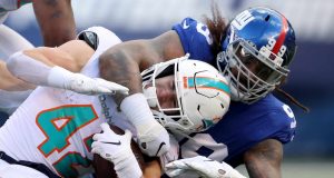 EAST RUTHERFORD, NEW JERSEY - DECEMBER 15: Leonard Williams #99 of the New York Giants tackles Patrick Laird #42 of the Miami Dolphins in the first half at MetLife Stadium on December 15, 2019 in East Rutherford, New Jersey.