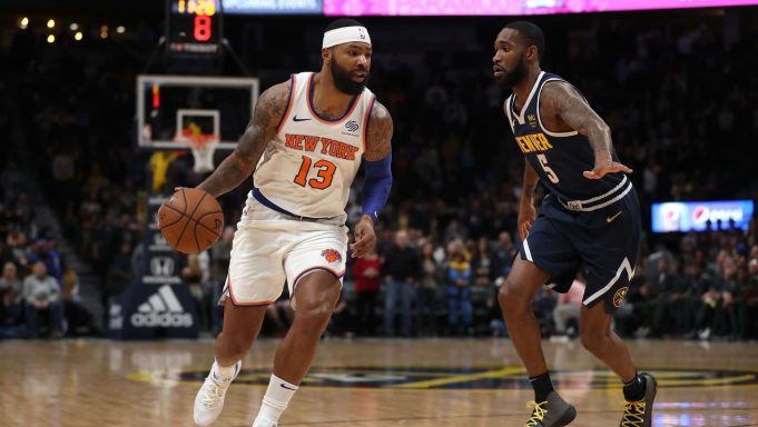 DENVER, COLORADO - DECEMBER 15: Marcus Morris Sr. #13 of the New York Knicks drives against Will Barton III #5 of the Denver Nuggets in the first quarter at the Pepsi Center on December 15, 2019 in Denver, Colorado. NOTE TO USER: User expressly acknowledges and agrees that, by downloading and or using this photograph, User is consenting to the terms and conditions of the Getty Images License Agreement.