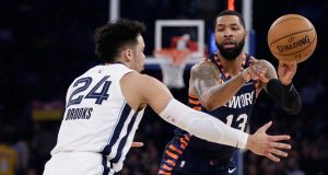 New York Knicks' Marcus Morris Sr. (13) passes the ball away from Memphis Grizzlies' Dillon Brooks (24) during the first half of an NBA basketball game Wednesday, Jan. 29, 2020, in New York.